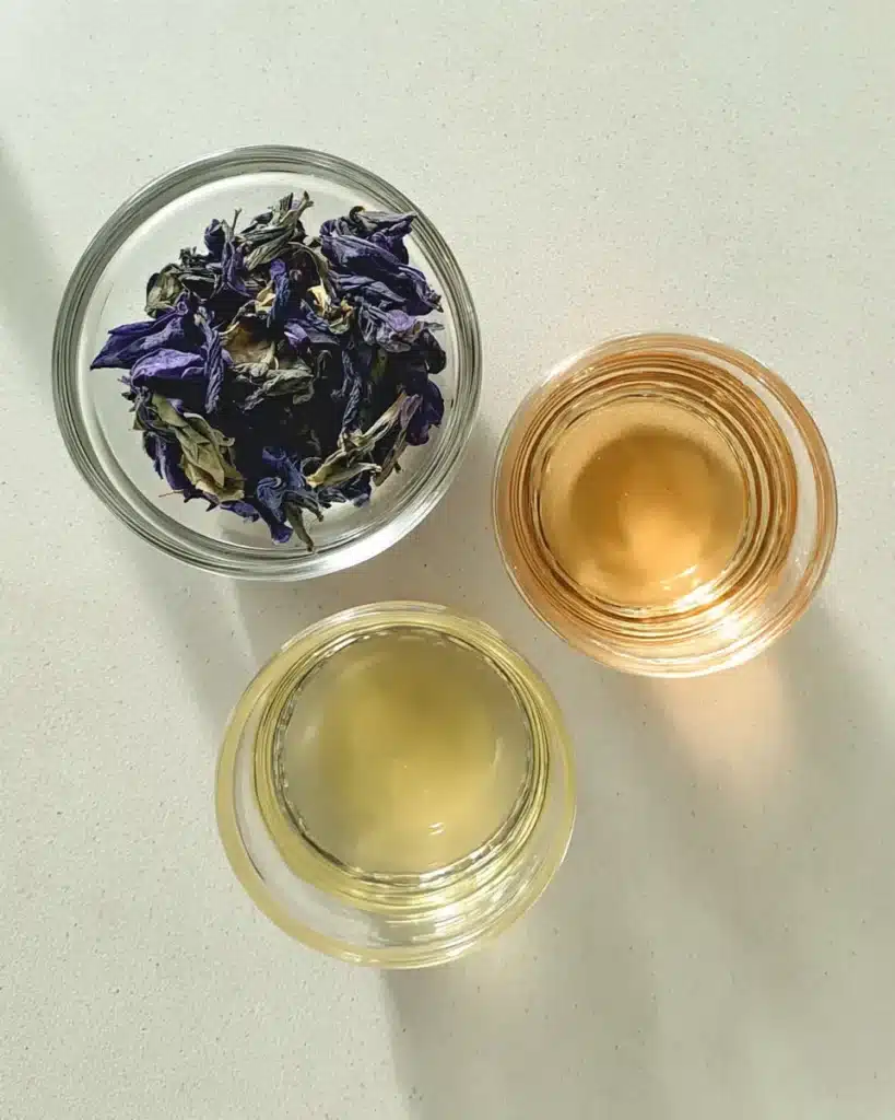Natural Mounjaro ingredients in glass bowls with butterfly pea flowers and vinegar