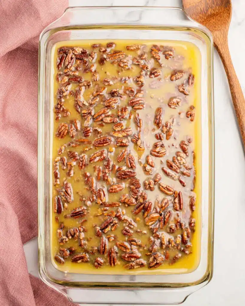 Pecan topping poured over brownie base before baking