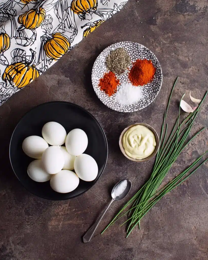 Ingredients for Pumpkin Patch Deviled Eggs on dark rustic surface