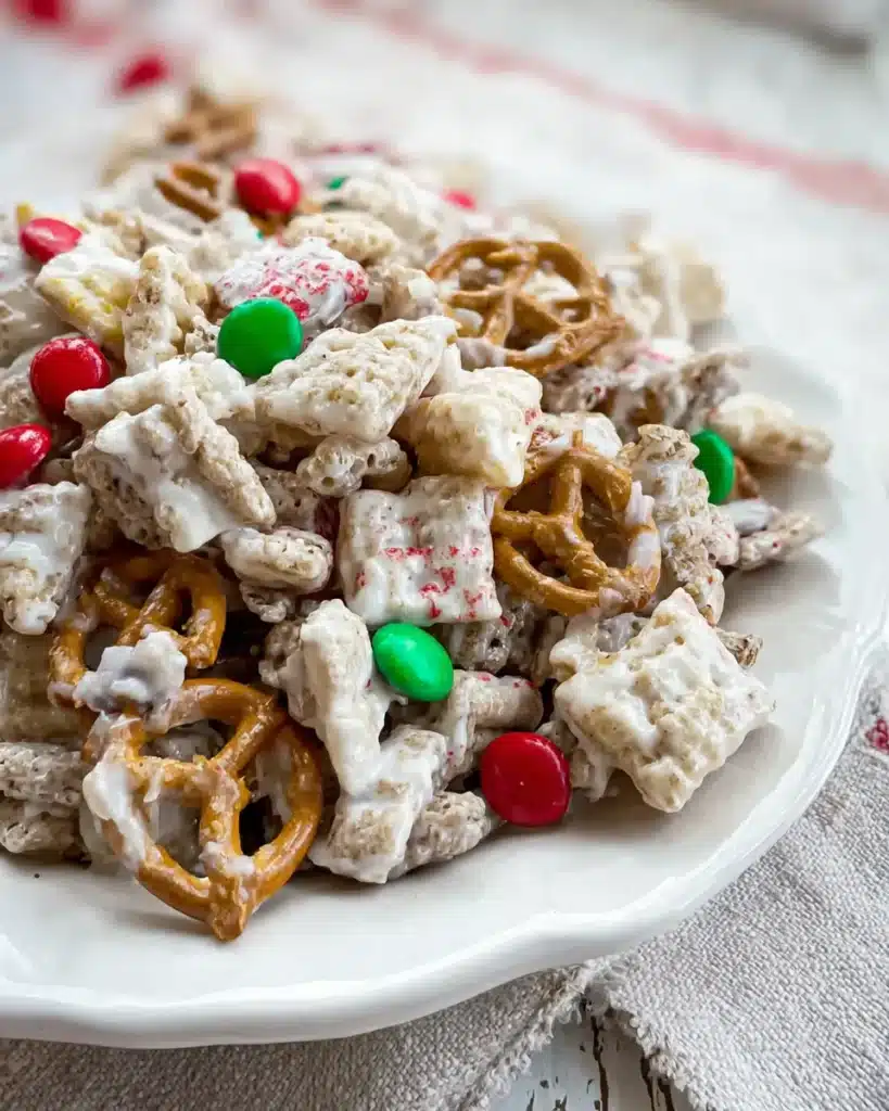 Close-up of reindeer chow snack mix with white chocolate, pretzels, popcorn, and Christmas candies