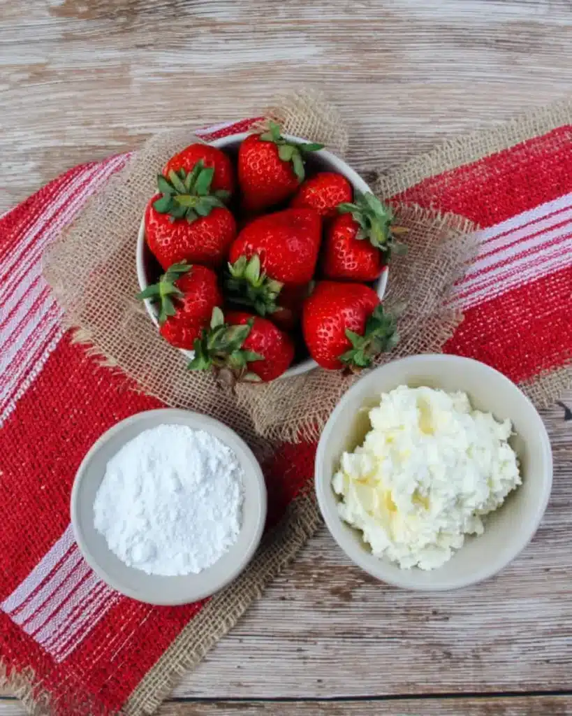 Strawberries, whipped cream cheese, and powdered sugar for Strawberry Santas