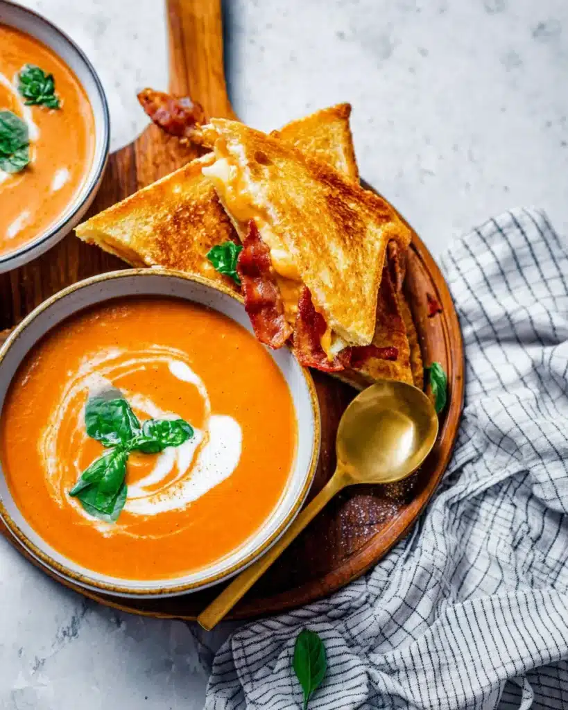 Creamy tomato bisque soup with grilled cheese and crispy bacon