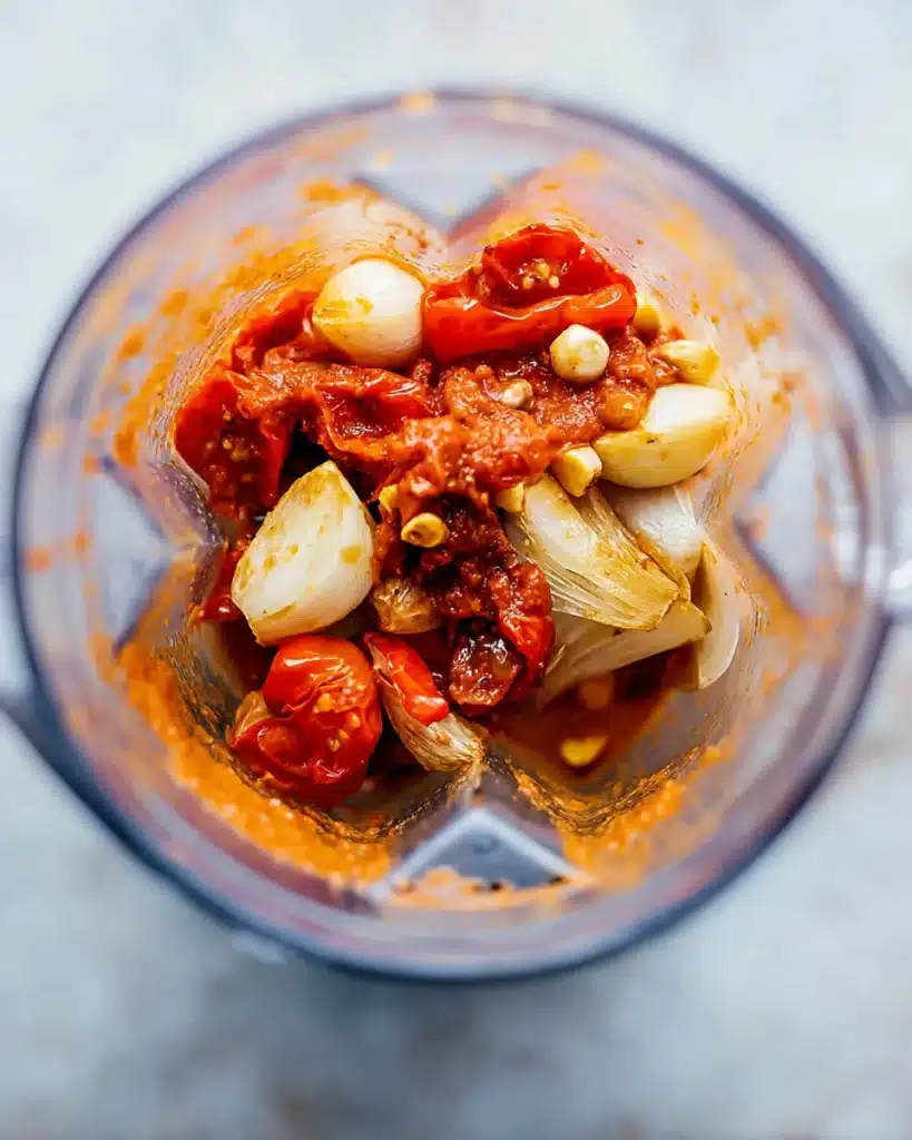 Roasted tomatoes, onions, and garlic in blender for tomato bisque soup