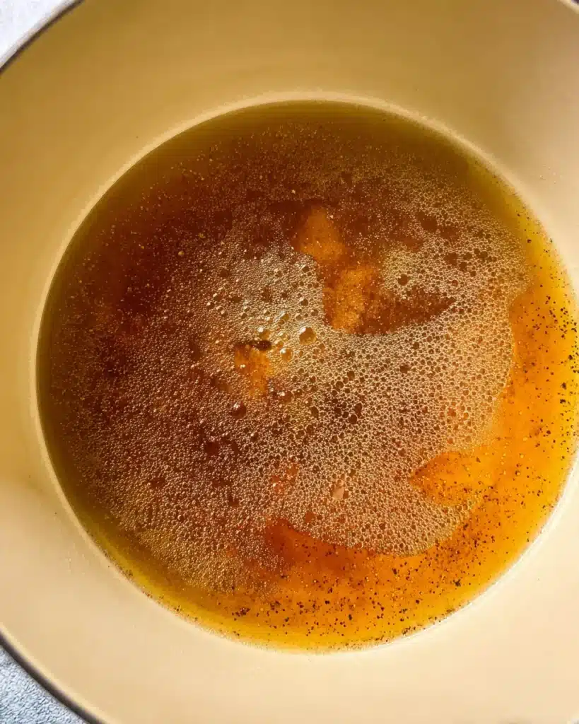 Simmering pineapple glaze for baked ham with honey and spices