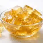 Featured bowl of gelatin trick recipe cubes on a white background